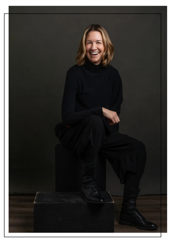 martha magrina image consultant in all black sitting on stool